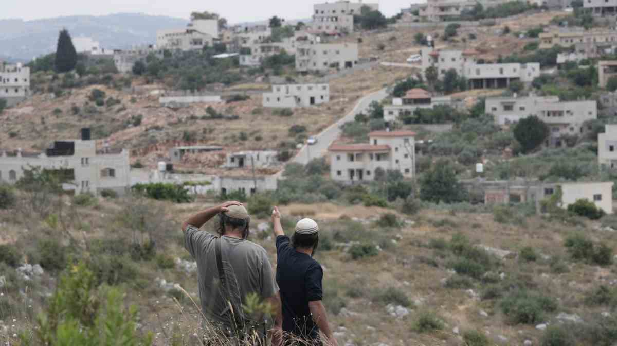 People look on near the Gaza Strip as seen from the Israel-Gaza border in southern Israel, Friday, May 16, 3025.  (AP Photo/Maya Alleruzzo)