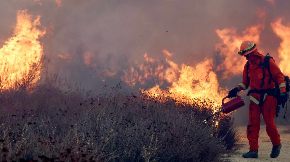 An inmate firefighter lights a backfire as the Hughes Fire burns north of Los Angeles on January 22, 2025 near Castaic, California.