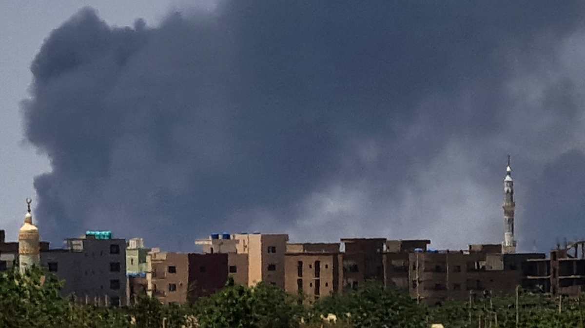 (FILES) Smoke billows over buildings in Khartoum on May 1, 2023 as deadly clashes between rival generals' forces have entered their third week. Famine was declared in Zamzam -- a massive decades-old displacement camp home to between 500,000 and a million people near North Darfur's besieged capital El-Fasher-- last July, according to the Integrated Food Security Phase Classification. The Sudanese government, aligned with the army, has denied reports of famine, even as millions across the country suffer on the brink of starvation amid the continuing 21-month war between the army and the Rapid Support Forces (RSF). (Photo by AFP)