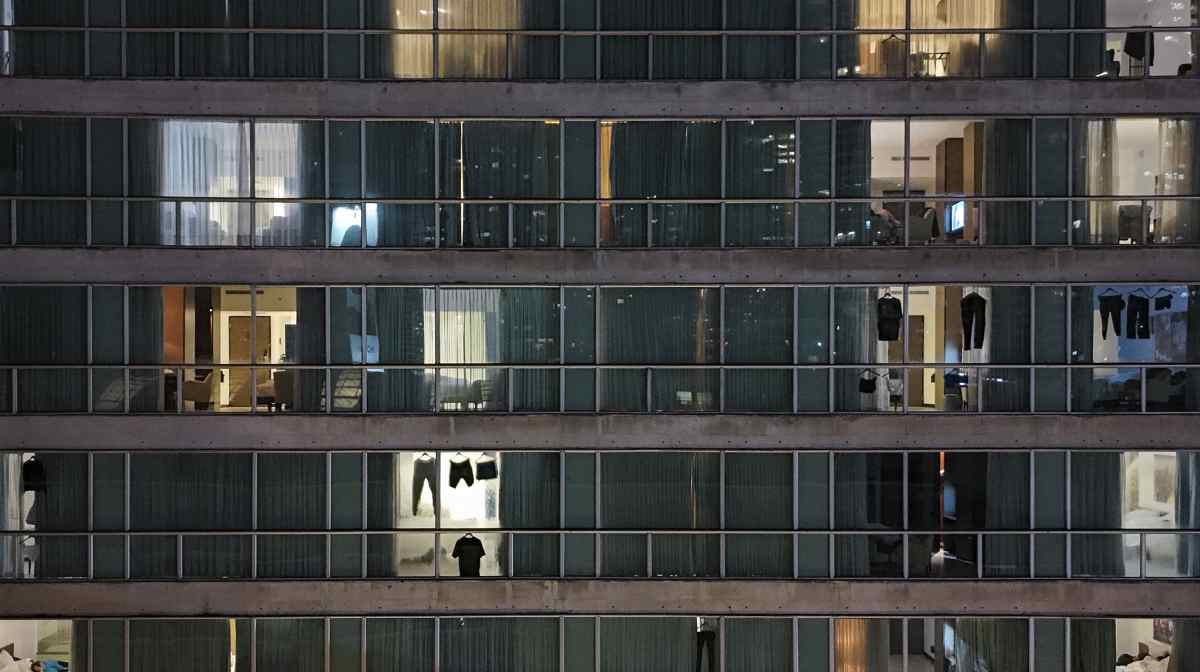 Clothes of migrants deported from the United States hang on windows inside a hotel in Panama City, Thursday, Feb. 20, 2025. (AP Photo/Matias Delacroix)