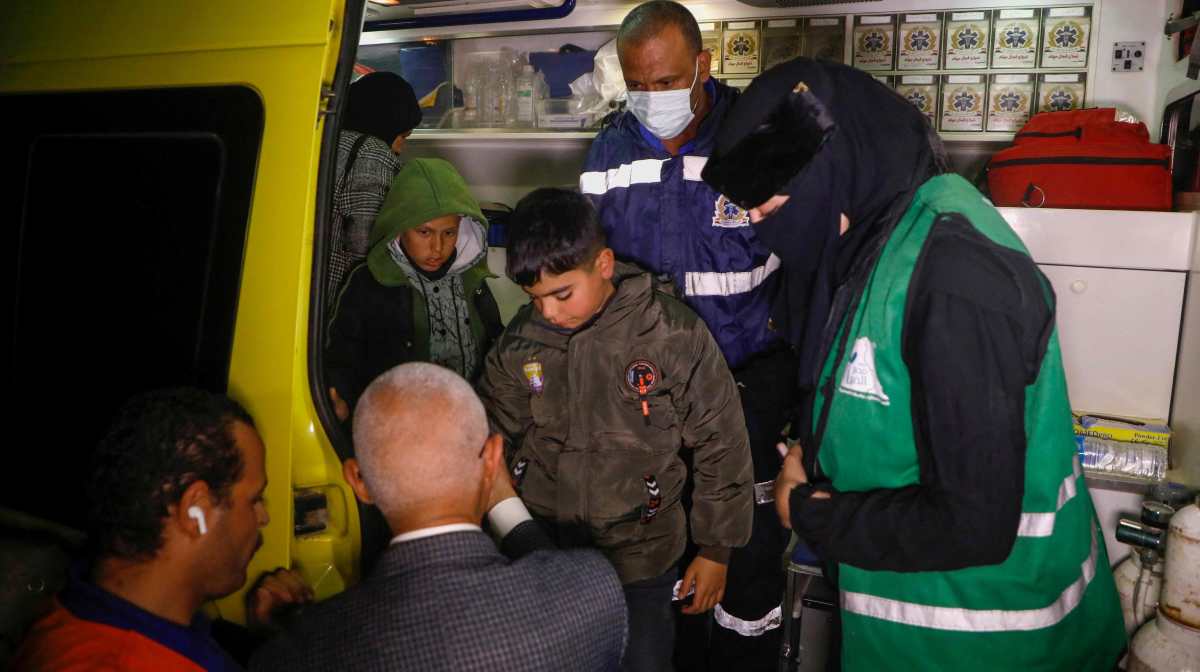 Egyptian medics care for a Palestinian patients evacuated from Gaza through the Rafah crossing | AFP