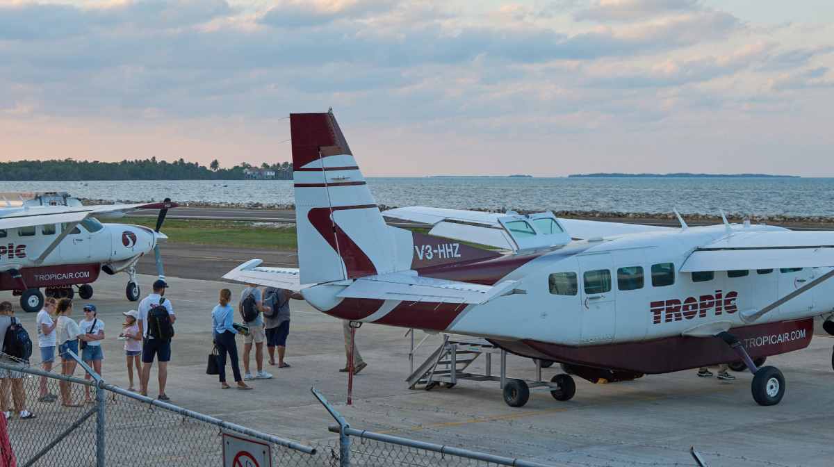 Tourists board a Tropic Air plane at the Sir Barry Bowen Municipal Airport in Belize City on April 17, 2025. A U.S. citizen armed with a knife attempted to hijack a small plane in Belize on Thursday but was shot and killed by a passenger, police said. (Photo by Jose A. Sanchez / AFP)
