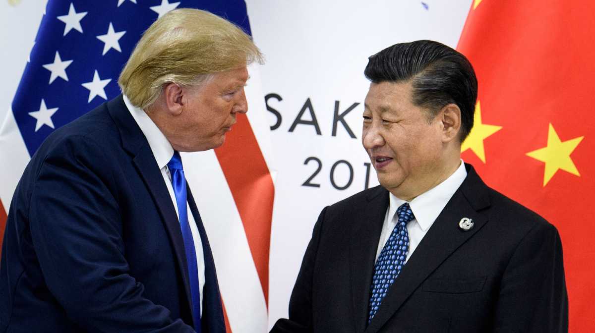 (FILES) This file photo taken on June 28, 2019 shows China's President Xi Jinping (R) shaking hands with US President Donald Trump before a bilateral meeting on the sidelines of the G20 Summit in Osaka. With his storm of tariffs on Chinese goods, US President Donald Trump on April 2025 has torched ties with Beijing and likely wrecked any hope of meeting his counterpart Xi Jinping in the near term, analysts say. (Photo by Brendan Smialowski / AFP) / To go with AFP story China-US-diplomacy-politics-trade-economy,ANALYSIS by Matthew Walsh