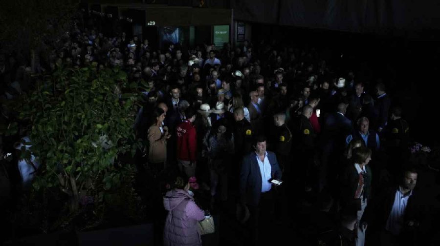 Spectators roam inside the Madrid Open tennis tournament venue during a general blackout in Madrid,