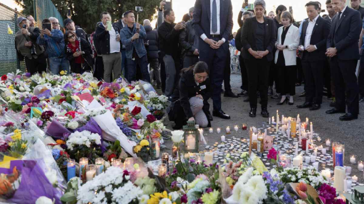 MLA Sunita Dhir lights a candle during the candlelight vigil near the scene where a car drove into a crowd of people during the Lapu Lapu Festival on April 27, 2025 in Vancouver