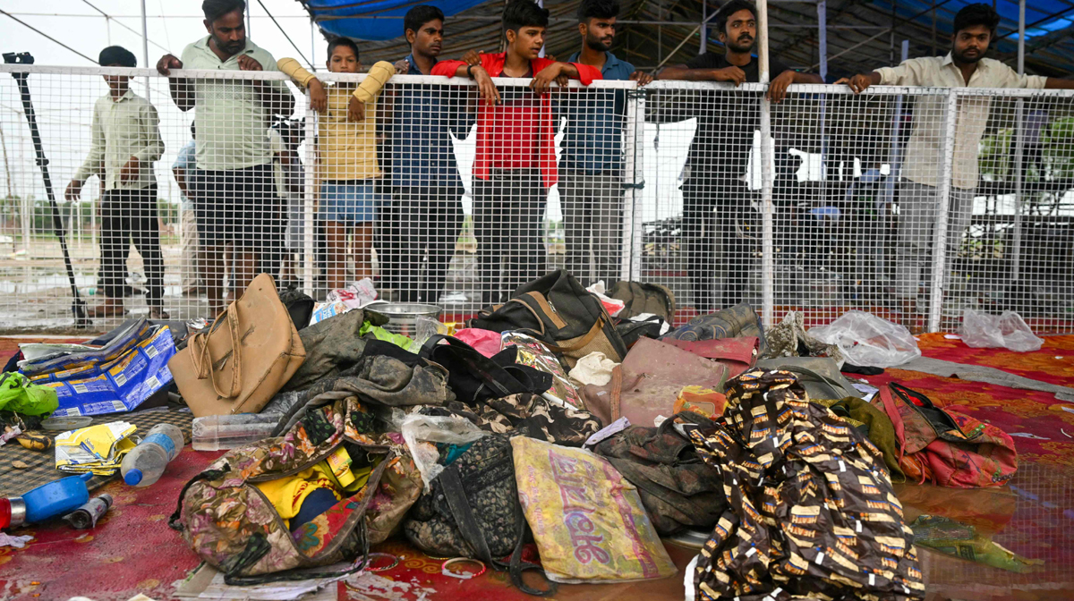 Men look at the stampede site that killed people during a sermon at Hathras in India's Uttar Pradesh state on July 3, 2024. Survivors of India's deadliest stampede in over a decade on July 3 recalled the horror of being crushed at a vastly overcrowded Hindu religious gathering that left 116 people dead. (Photo by Arun SANKAR / AFP)