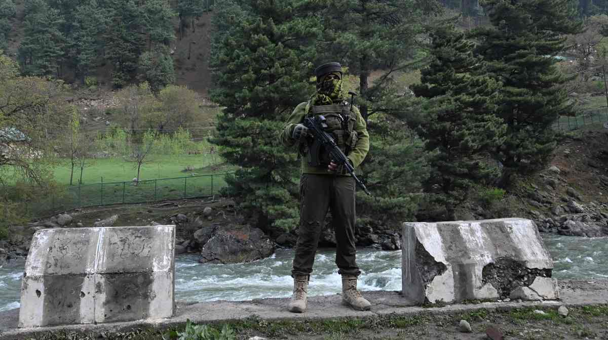 An Indian paramilitary serviceman keeps watch in Pahalgam, south of Srinagar on April 23, 2025, following an attack. At least 26 people were killed April 22 in Indian-administered Kashmir when gunmen opened fire on tourists, security sources told AFP, in the insurgency-hit region's deadliest attack on civilians since 2000. (Photo by TAUSEEF MUSTAFA / AFP)
