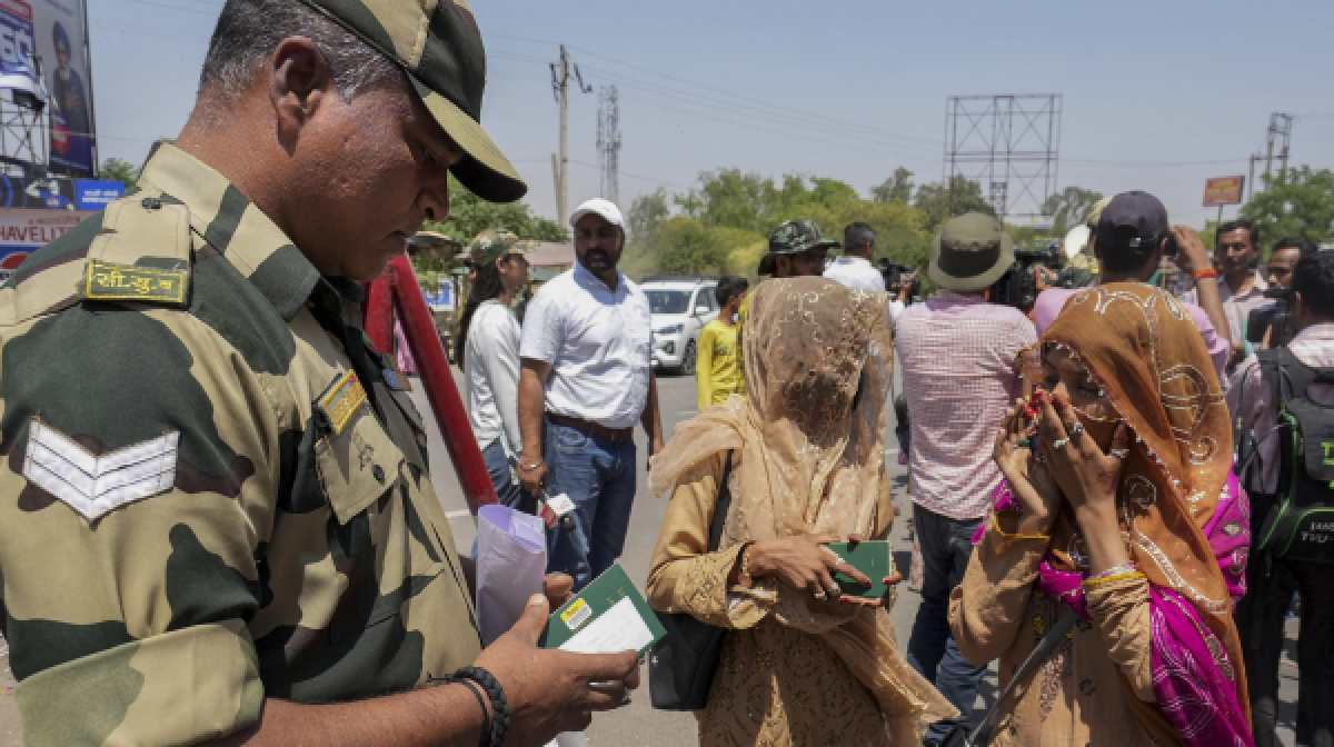 A BSF personnel checks documents of Pakistani nationals arriving to cross over to their country as the deadline to exit India nears its end, amid escalating tensions between the two countries over the Pahalgam terror attack, at the Attari-Wagah border point, near Amritsar, Sunday, April 27, 2025. (PTI Photo/Shiva Sharma)