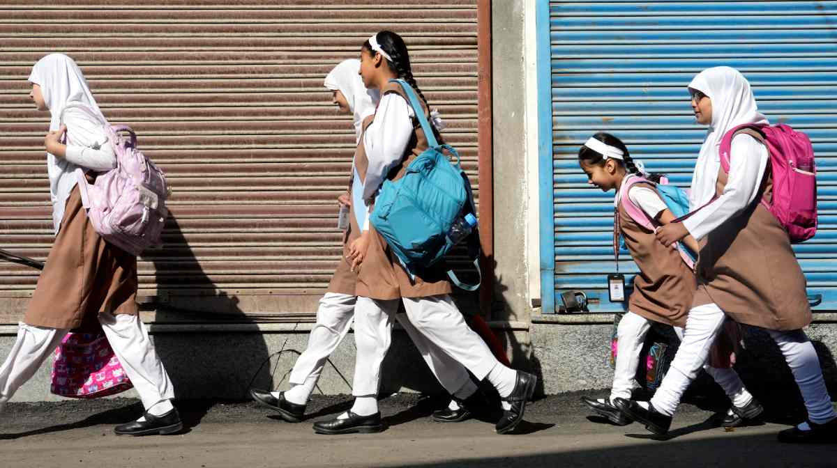 Srinagar: Students head to their school as educational institutions reopen in non-border districts of Jammu and Kashmir after remaining closed for nearly a week due to India-Pakistan tensions, in Srinagar, Tuesday, May 13, 2025. (PTI Photo/S Irfan) (PTI05_13_2025_000010B)