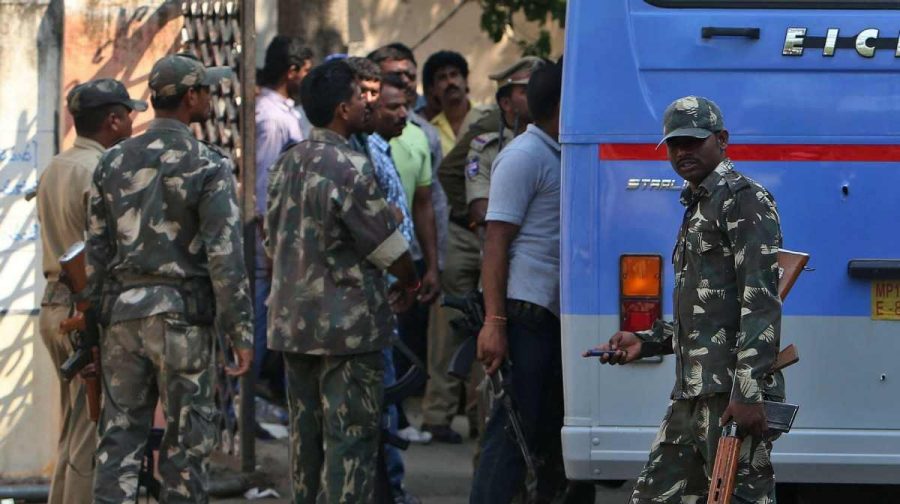 Indian police officers, inside, inspect the bodies five prisoners who were shot dead by police after the vehicle from which they allegedly tried to escape is brought to a government hospital at Janagam, Warangal district, Telangana state, India, Tuesday, April 7, 2015. Police were transferring the five men from Warangal city to a court in Hyderabad.(AP Photo/Mahesh Kumar A)                                                                                                                                                                 