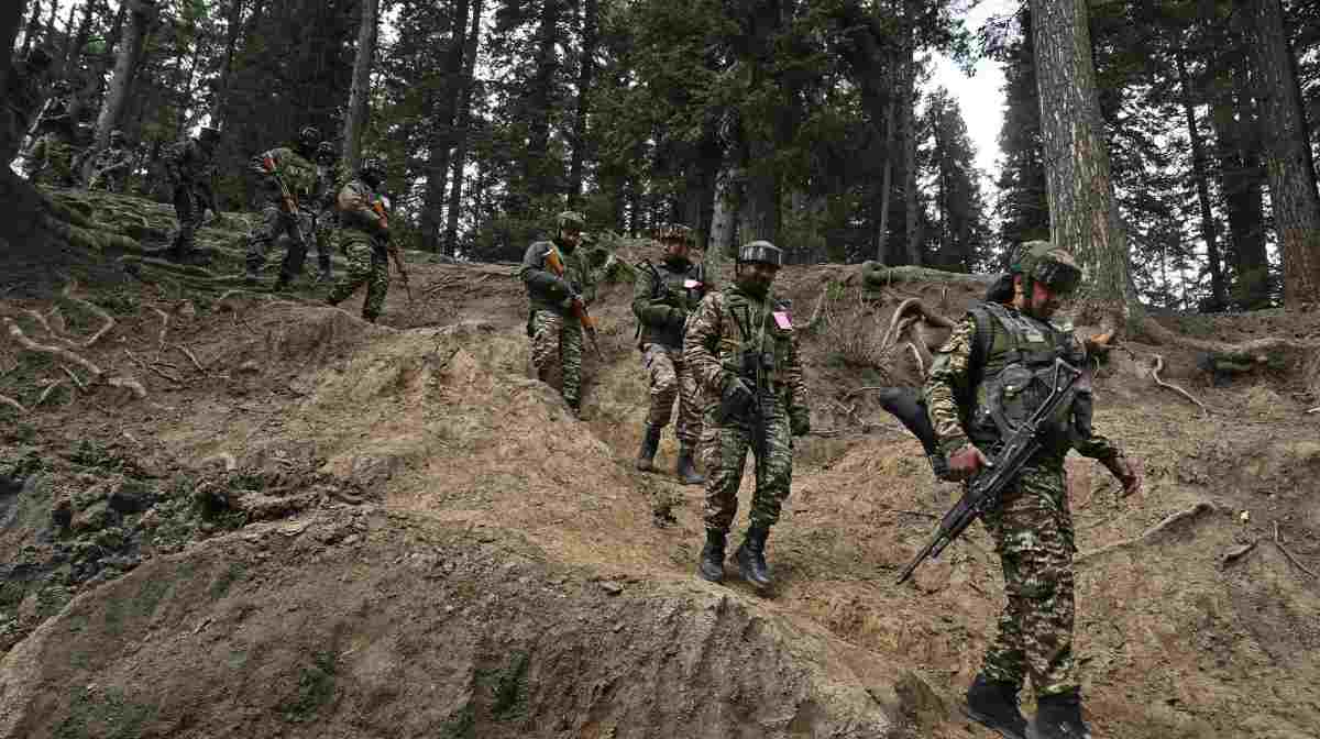 TOPSHOT - Indian soldiers trek back after a search operation around Baisaran meadow in the aftermath of an attack in Pahalgam, about 90kms (55 miles) from Srinagar on April 23, 2025. Indian security forces in Kashmir carried out a major manhunt on April 23, a day after gunmen opened fire on tourists killing 26 people in the region's deadliest attack on civilians since 2000. (Photo by TAUSEEF MUSTAFA / AFP)