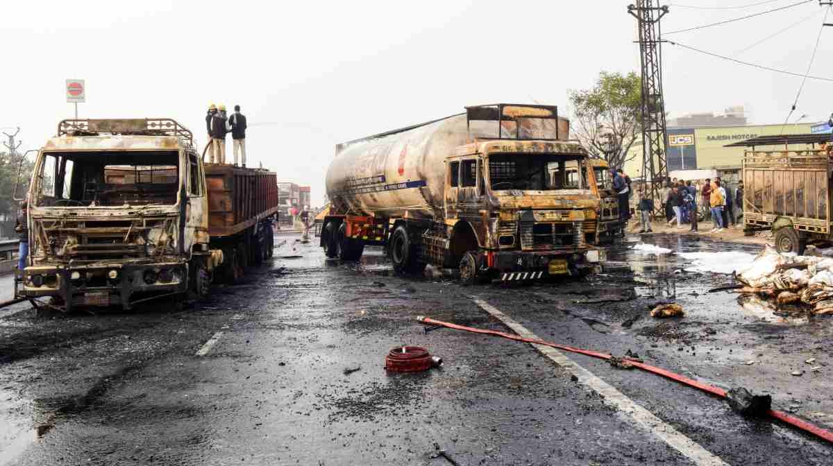 Firefighters extinguish the fire at the site of the accident after a massive fire started due to a collision between a gas tanker and multiple vehicles near a petrol pump on the Jaipur-Ajmer Highway, in Jaipur on Friday.