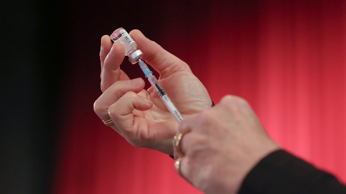 A medical worker puts a vial into a syringe at a vaccination centre inside Harpenden Public Halls, amid the outbreak of the coronavirus disease (COVID-19) in Harpenden, Britain, January 22, 2021. REUTERS/Peter Cziborra
