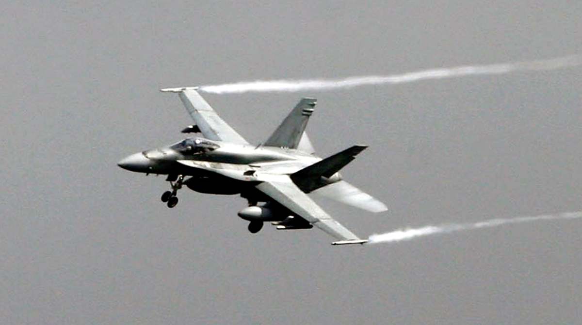 An F-18 Hornet jet fighter maneuvers over the NATO airbase of Birgi, near Trapani, Sicily, Italy, Saturday, March 19, 2011. Six Danish F-16 fighter jets landed Saturday at the U.S. air base in Sicily, and U.S., Canadian and Spanish F-18s flew into the region as the international military buildup mounted in Italy for action against Libya. Italy has offered the use of seven military bases to help enforce the U.N.-authorized no-fly zone over Libya and protect Libyan civilians from Moammar Gadhafi's troops. And Premier Silvio Berlusconi on Saturday proposed using the NATO base in Naples as the main coordination point for the operation. (AP Photo/Carmelo Imbesi)