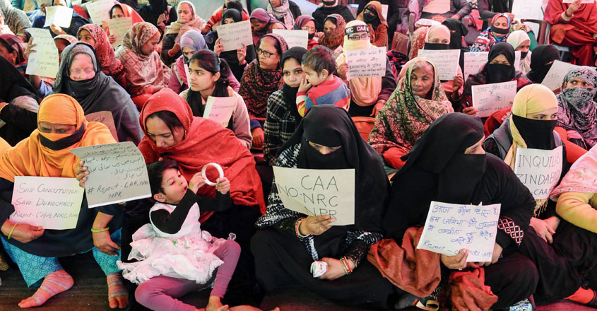 New Delhi: Women and children hold placards during a silent protest against CAA and NRC at Shaheen Bagh in New Delhi, Tuesday, Feb. 11, 2020. (PTI Photo)(PTI2_11_2020_000243B)