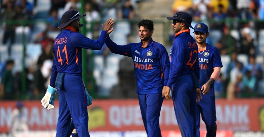 India's Kuldeep Yadav (C) celebrates with teammates after taking the wicket of South Africa's Anrich Nortje (not pictured) during the third and final one-day international (ODI) cricket match between India and South Africa at the Arun Jaitley Stadium in New Delhi on October 11, 2022. (Photo by Sajjad HUSSAIN / AFP) / ----IMAGE RESTRICTED TO EDITORIAL USE - STRICTLY NO COMMERCIAL USE-----