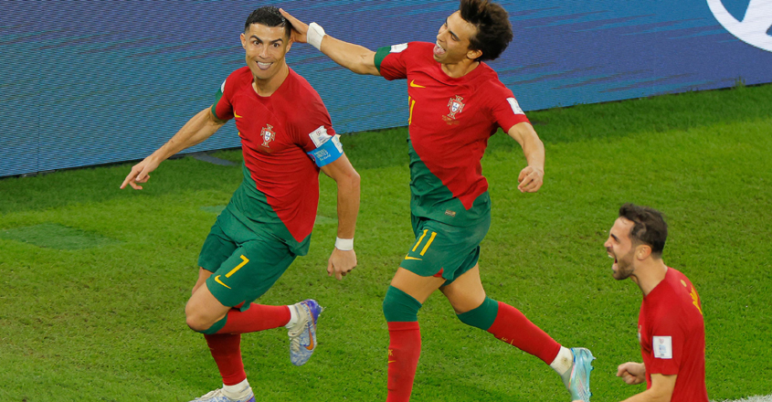 Portugal's forward #07 Cristiano Ronaldo celebrates with Portugal's forward #11 Joao Felix and Portugal's midfielder #10 Bernardo Silva after scoring his team's first goal from the penalty spot during the Qatar 2022 World Cup Group H football match between Portugal and Ghana at Stadium 974 in Doha on November 24, 2022. (Photo by Odd ANDERSEN / AFP)