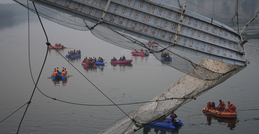 Rescuers on boats search for people in the Machchu river next to a century-old cable suspension bridge that collapsed on Sunday in Morbi town of the western state Gujarat, India, Monday, Oct. 31, 2022. (AP Photo/Ajit Solanki)