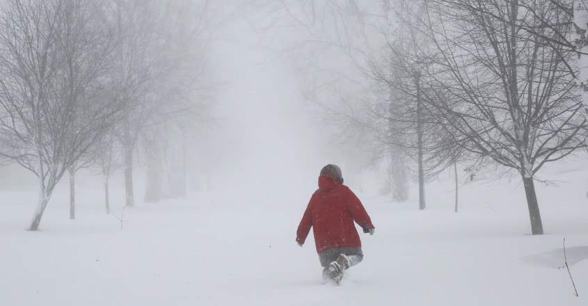 A person walks on the street as a winter storm rolls through Western New York Saturday, Dec. 24, 2022, in Amherst N.Y. A battering winter storm has knocked out power to hundreds of thousands of homes Â homes and businesses across the United States on Saturday. It left millions more to worry about the prospect of further outages and crippled police and fire departments. AP/PTI(AP12_25_2022_000016A)