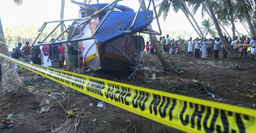 People look at a tourist boat that capsized Sunday night in Malappuram, Kerala, India, Monday, May 8, 2023. More than a dozen were killed. (AP /PTI)(AP05_08_2023_000091B)