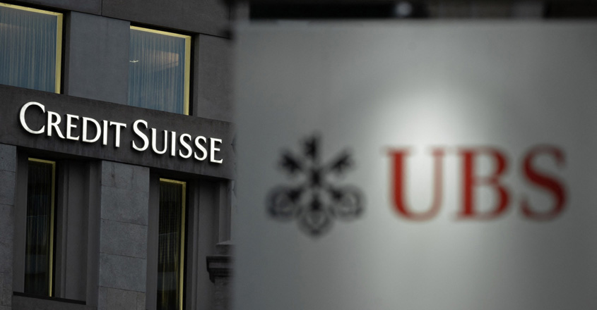 This photo taken on on November 4, 2020, shows a sign of Credit Suisse bank, seen behind a sign of Swiss bank UBS, in Geneva. - Switzerland's largest bank, UBS, is in talks to buy all or part of Credit Suisse, according to a report by the Financial Times. Credit Suisse -- Switzerland's second-biggest bank -- came under pressure as the failure of two US regional lenders rocked the sector. (Photo by Fabrice COFFRINI / AFP)