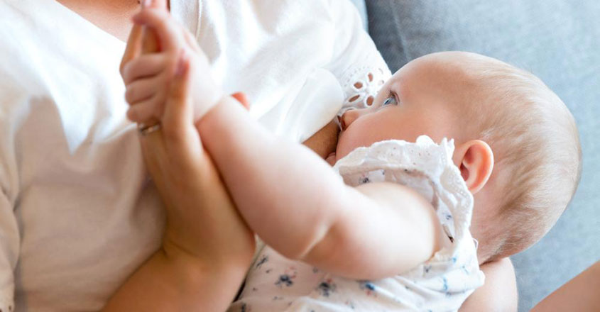 portrait Of A Loving Mother In Sofa Breastfeeding Baby Girl. Newborn Child Fed With Breast portrait Of A Loving Mother In Sofa Breastfeeding Baby Girl. Newborn Child Fed With Breast