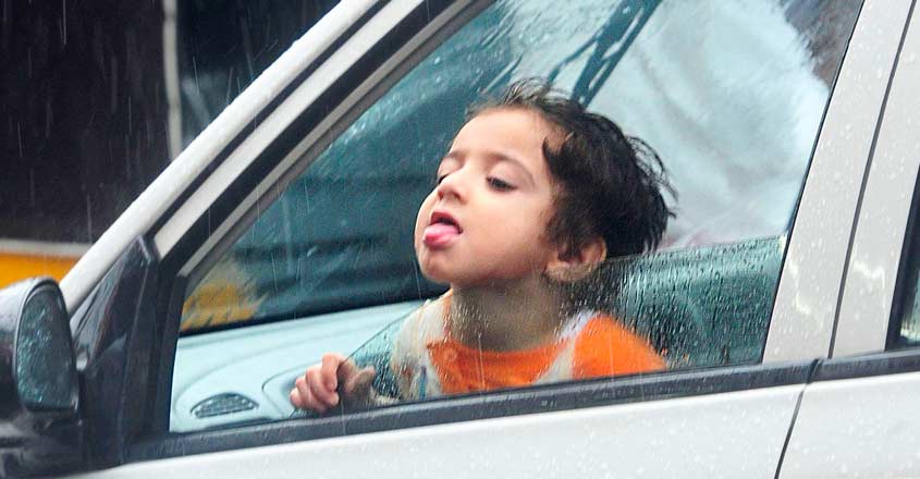 kid-enjoying-rain kid-enjoying-rain
