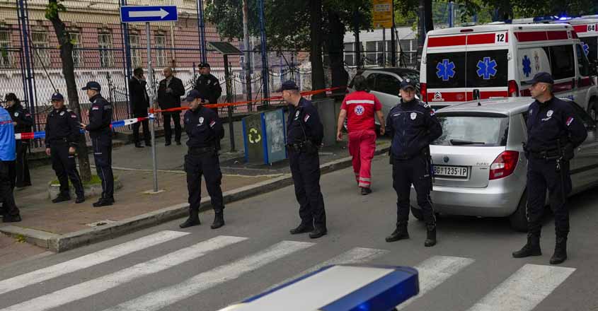 Police officers block the street around the Vladislav Ribnikar school in the very center of Belgrade, Serbia, Wednesday, May 3, 2023. A teenage boy opened fire early Wednesday in a school in central Belgrade, causing injuries, Serbian police said. (AP Photo/Darko Vojinovic)