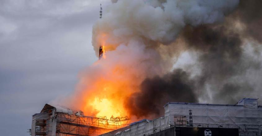 The tower of the historic Boersen stock exchange stands in flames as the building is on fire in central Copenhagen, Denmark on April 16, 2024