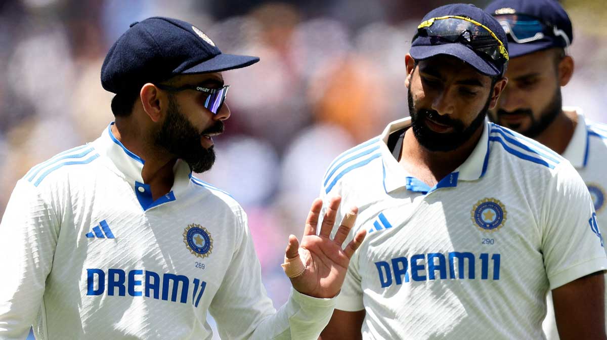 India's Virat Kohli (L) chats to Jasprit Bumrah as they leave the field for the lunch break on day four of the fourth cricket Test match between Australia and India at the Melbourne Cricket Ground : Image AFP