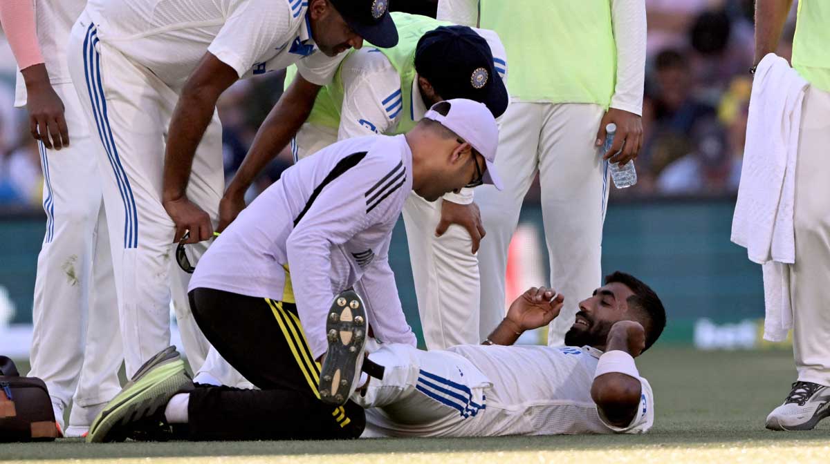 Jasprit Bumrah receives treatment to his leg on the second day of the second Test cricket match between Australia and India at the Adelaide Oval / AFP