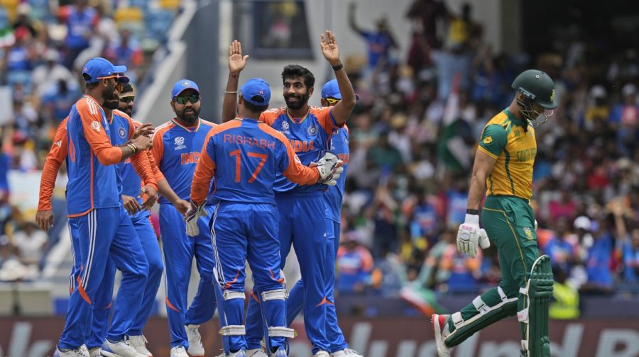 South Africa's Reeza Hendricks, right, leaves the field after losing his wicket to India's Jasprit Bumrah, centre, with his arms raised, during the ICC Men's T20 World Cup final cricket match between India and South Africa at Kensington Oval in Bridgetown, Barbados, Saturday, June 29, 2024. (AP Photo/Ramon Espinosa)