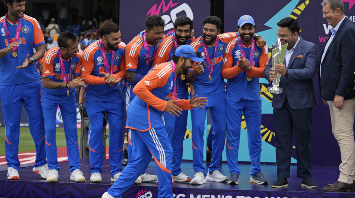 India's captain Rohit Sharma gestures playfully as he walks to collect the winners' after India won the ICC Men's T20 World Cup final cricket match against South Africa at Kensington Oval in Bridgetown, Barbados, Saturday, June 29, 2024. (AP Photo/Ramon Espinosa)