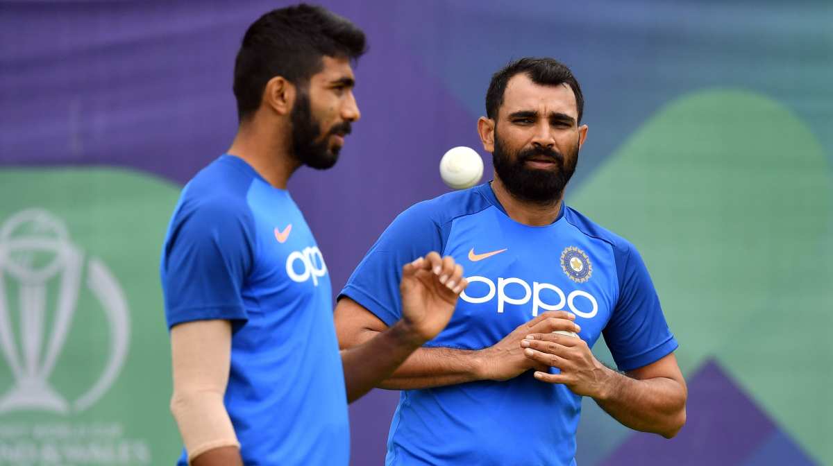 India's bowlers Mohammed Shami (L) and Jasprit Bumrah attend a training session at the Hampshire Bowl in Southampton on June 20, 2019, ahead of their 2019 World Cup cricket match against Afghanistan. (Photo by Saeed KHAN / AFP)