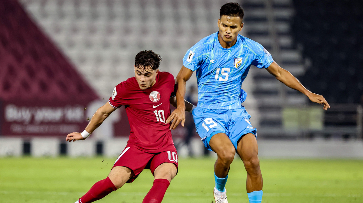 Qatar's forward #10 Ahmed Al-Rawi and India's midfielder #15 Jeakson Singh vie for the ball during the 2026 FIFA World Cup AFC qualifiers football match between Qatar and India at the Jassim Bin Hamad Stadium in Doha on June 11, 2024. (Photo by Karim JAAFAR / AFP)