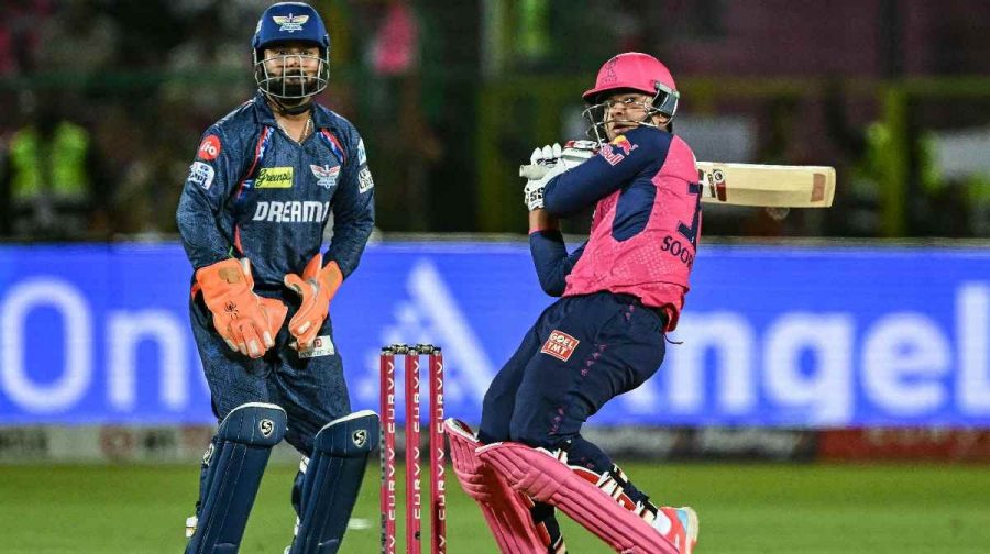 Vaibhav Suryavanshi (R) plays a shot as Lucknow Super Giants' wicketkeeper captain Rishabh Pant watches