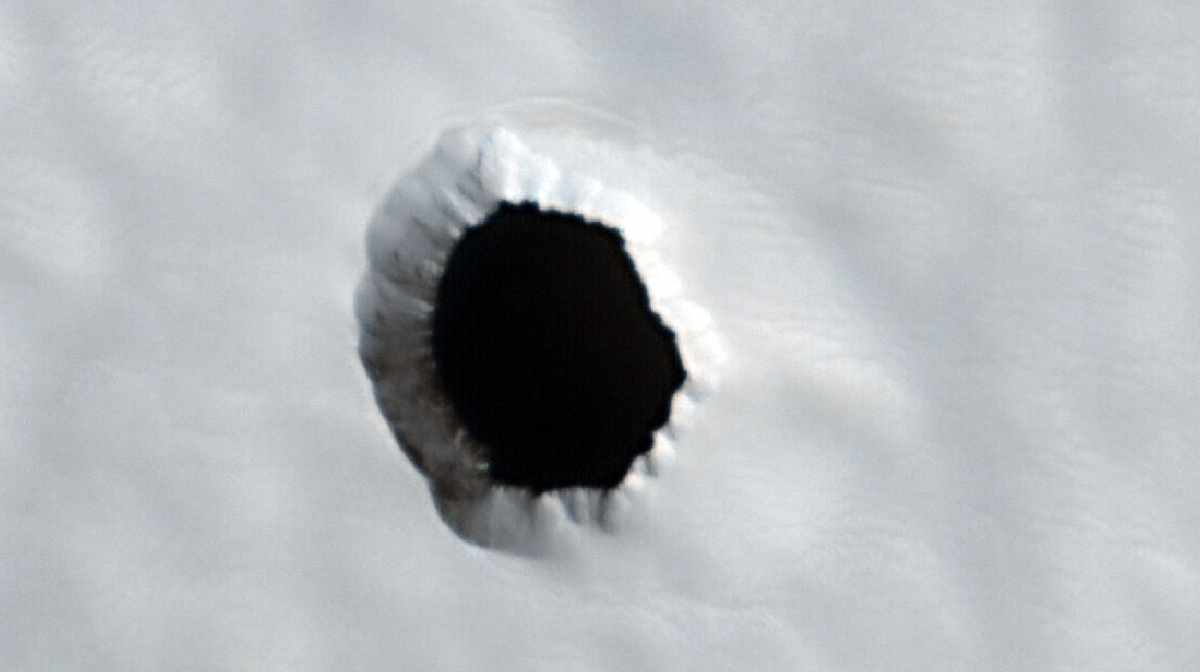 Mysterious hole in Arsia Mons, captured by the HiRISE camera on NASA's Mars Reconnaissance Orbiter. Photo Credit: NASA/JPL-Caltech/UArizona