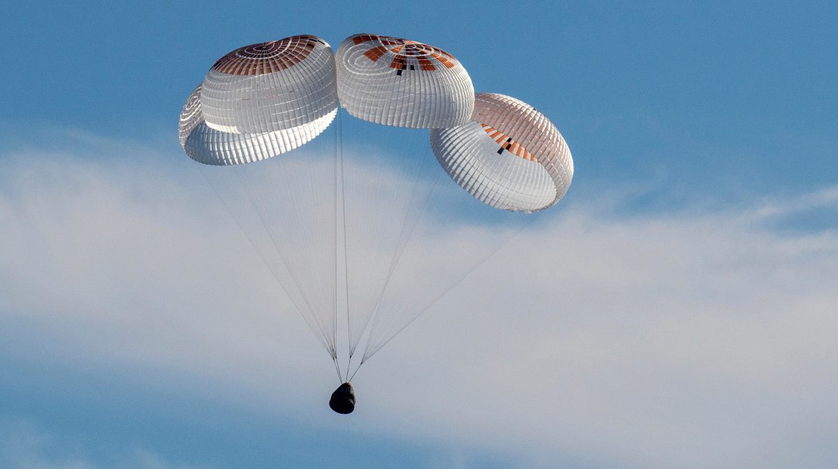 In this image provided by NASA, a SpaceX capsule floats over the Gulf of Mexico, Tuesday, March 18, 2025, as it lands off the coast of Florida with NASA astronauts Suni Williams, Butch Wilmore and Nick Hague, and Russian cosmonaut Alexander Gorbunov. (Keegan Barber/NASA via AP)