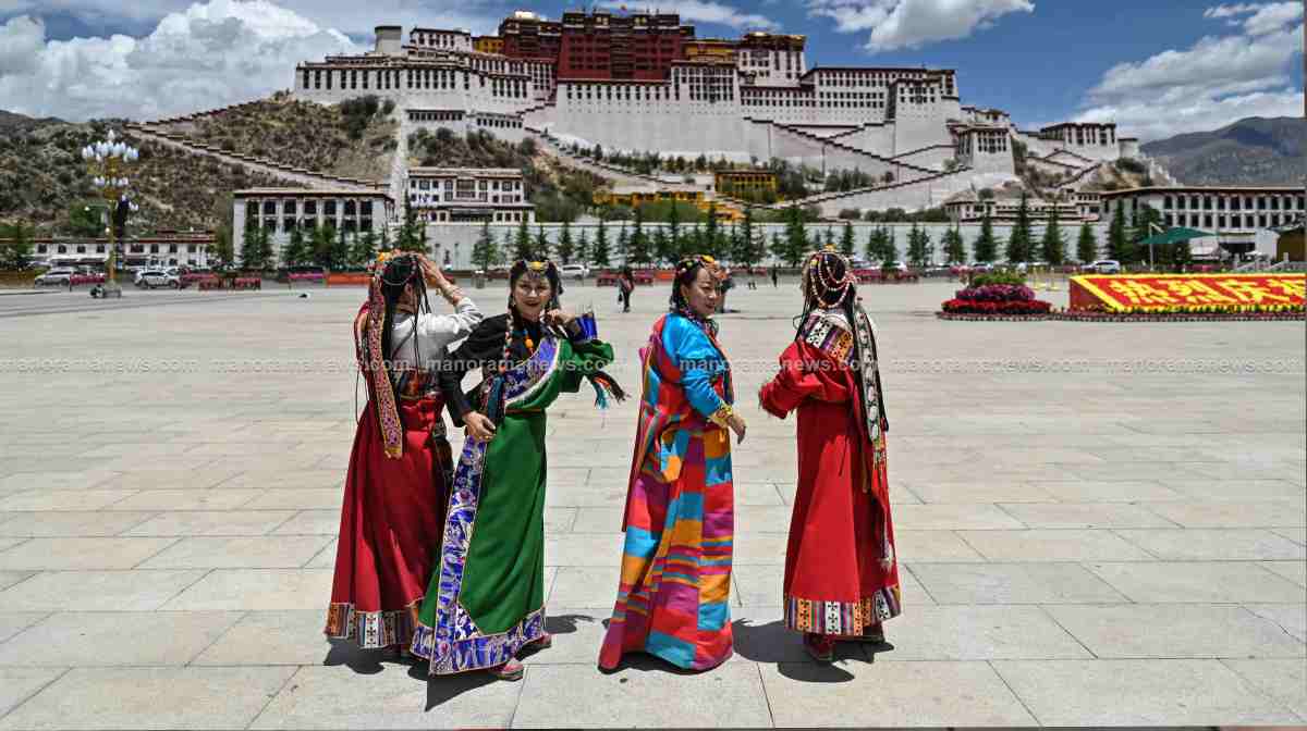 People in traditional costume standing in Potala Palace Square as the Potala Palace. (File Image)